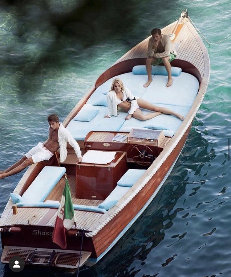 Guests aboard a classic Italian wooden motor launch on the Riviera