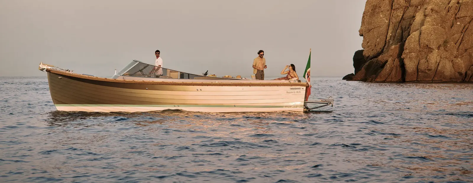 A wooden sail boat on the calm Mediterranean at dawn